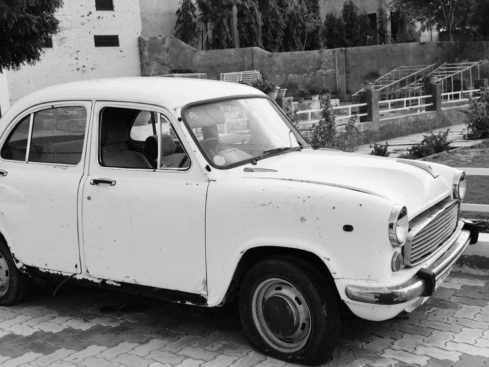 A white vintage car photographed in black and white